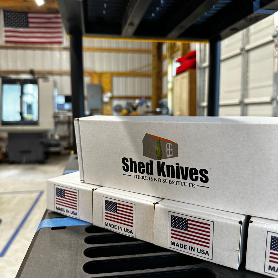 Shed Knives U.S. workshop CNC milling station producing blades with boxes on shelf showing high standards.