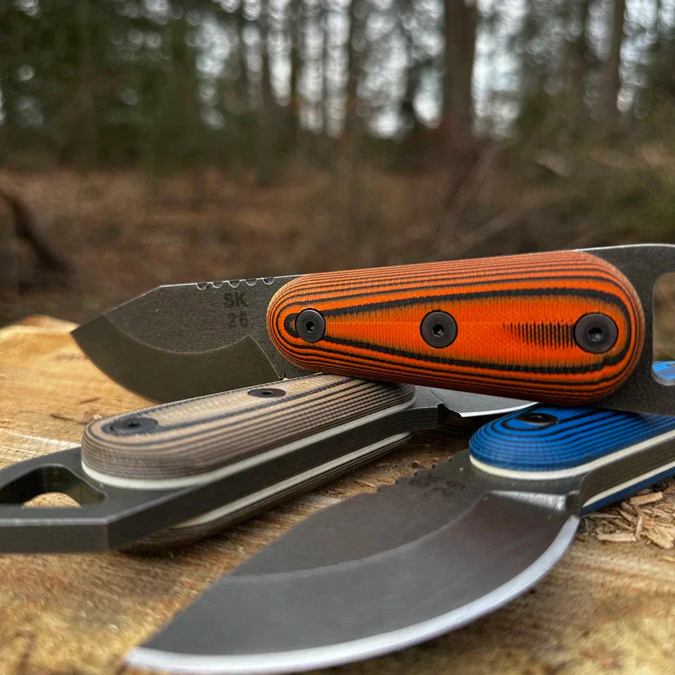 Skur knife handle featuring 3D contoured G-10 scales in Skur Orange with matte black Allen screws, designed for secure outdoor grip.