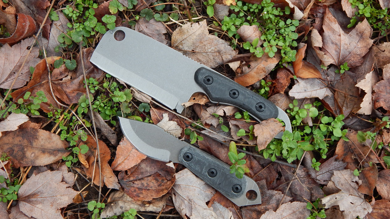 2023 Shed Knives Skur & Atlas in Midnight Black G-10 on the ground with leaves.